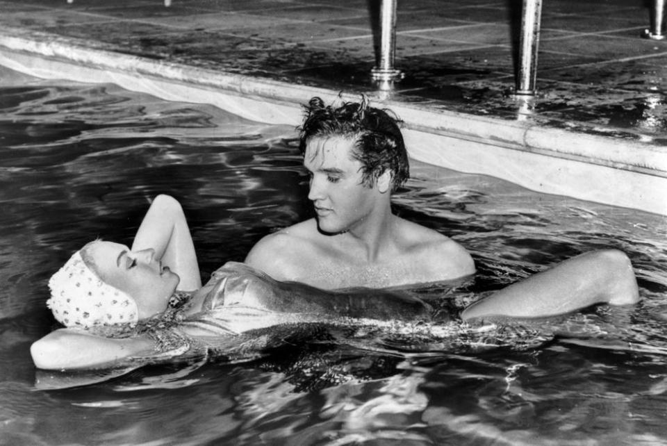 <p>Elvis Presley and his <em>Jailhouse Rock</em> costar Jennifer Holden spend time together in a pool, circa 1957.</p>