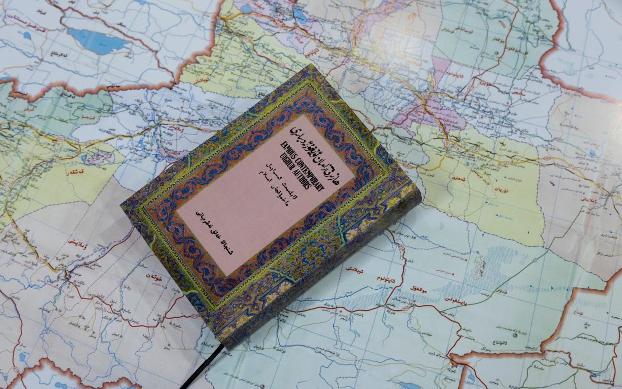 Treasured book rests on map of Uyghur homeland