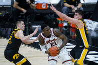 Illinois center Kofi Cockburn (21) looks to shoot between Iowa guard CJ Fredrick (5) and center Luka Garza (55) in the first half of an NCAA college basketball game at the Big Ten Conference tournament in Indianapolis, Saturday, March 13, 2021. (AP Photo/Michael Conroy)