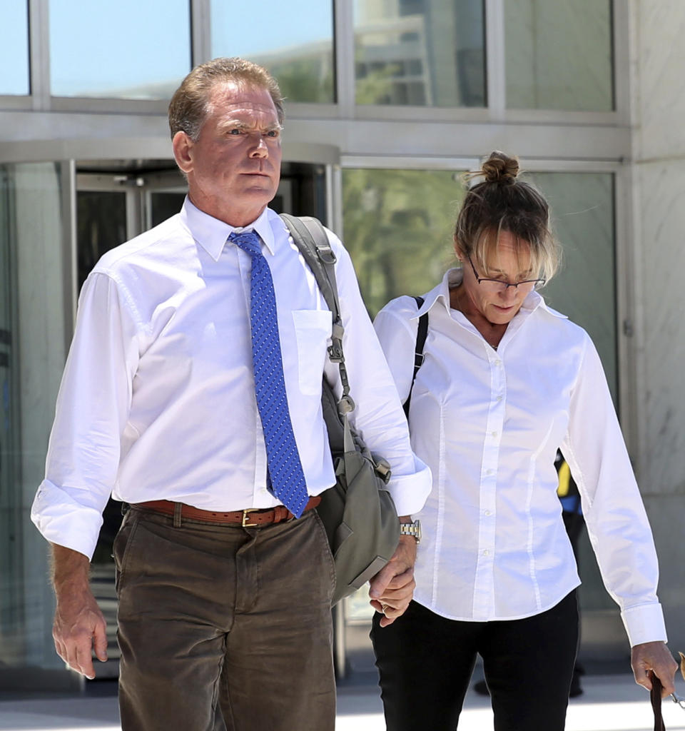 FILE - In this July 10, 2019, file photo, Douglas Haig, left, the Arizona man who sold ammunition to the Route 91 Harvest festival gunman, and his wife, Dori, leave the Lloyd George Federal Courthouse in Las Vegas. Haig is due to plead guilty to illegally manufacturing tracer and armor-piercing bullets found in a high-rise hotel suite from which a gunman carried out the Las Vegas Strip massacre two years earlier. (Bizuayehu Tesfaye/Las Vegas Review-Journal via AP, File)