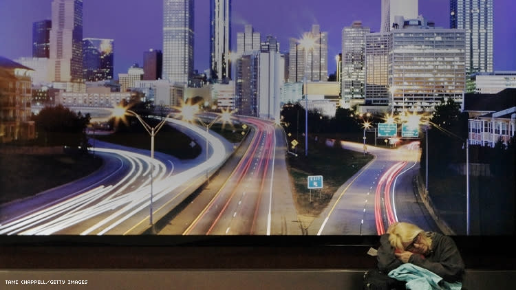 Woman sleeps in Atlanta airport under picture of the city