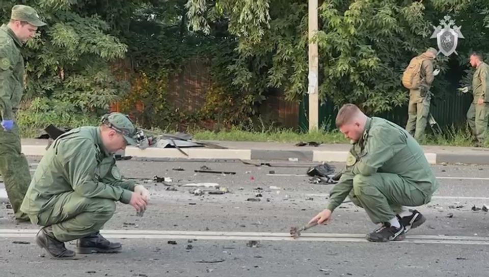 Russian officials investigate the scene after the car of Darya Dugina, daughter of Alexander Dugin, Russian political scientist and ally of President Vladimir Putin exploded. 