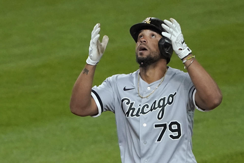 Chicago White Sox's Jose Abreu reacts as he crosses the plate after he hit a grand slam during the eighth inning of a baseball game against the Seattle Mariners, Tuesday, April 6, 2021, in Seattle. (AP Photo/Ted S. Warren)