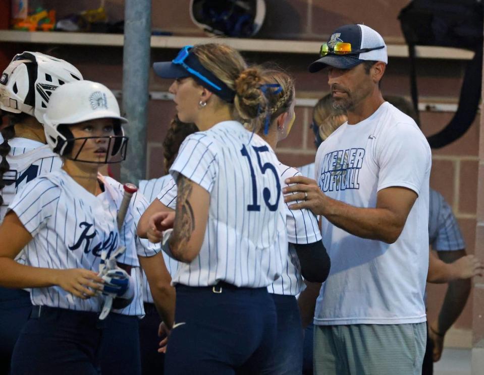 Keller head coach Chad Cribbs talks with his pitcher Sadie Beck (7) between innings during the Conference 6A Region 1 Regional Finals at Coppell Softball Field in Coppell, Texas, Saturday May 25, 2024.