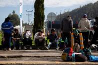 Venezuelan migrants line up to register at a migrant service point run by the International Rescue Committee (IRC) in Chusaca