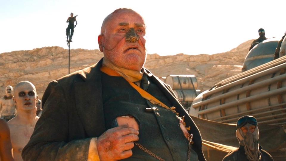 The bald People Eater in his black suit and fake gold nose in Mad Max: Fury Road