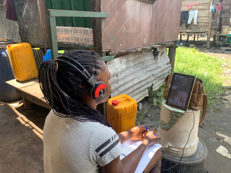 Esther Ikechukwu, a beneficiary of Slum2School project, attends a virtual class from her home in Makoko, Lagos