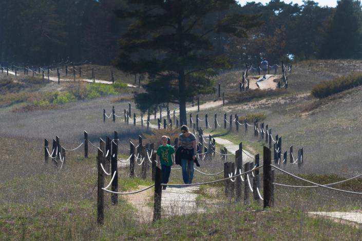 People hike the Kohler Dunes cord walk in May 2021 at the north end of Kohler-Andrae State Park.