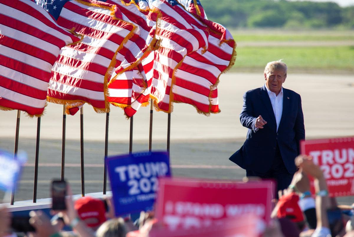 Supporters cheer as former president Donald Trump steps off the plane to the podium at his first 2024 campaign rally in Waco, Texas on Mar. 25, 2023.