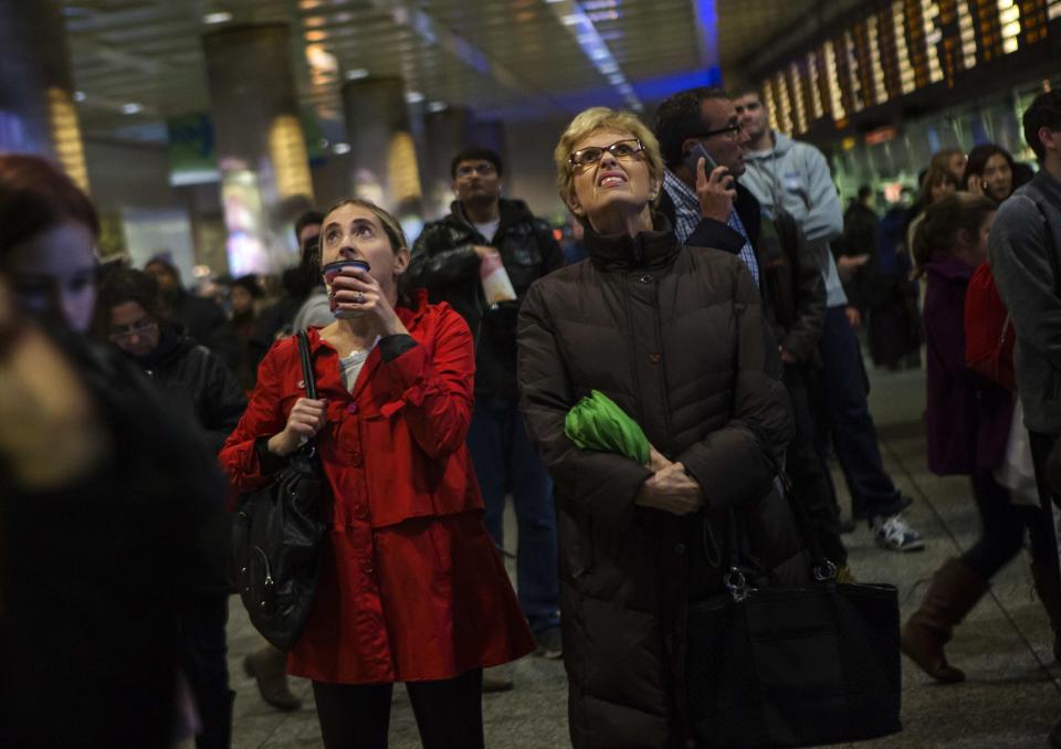 Travelers wait at Pennsylvania Station in New York