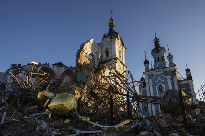A cupola lies on the ground in front of the Orthodox Church which was destroyed by Russian forces in the recently retaken village of Bogorodychne, Ukraine, Saturday, Jan. 7, 2022. (AP Photo/Evgeniy Maloletka)