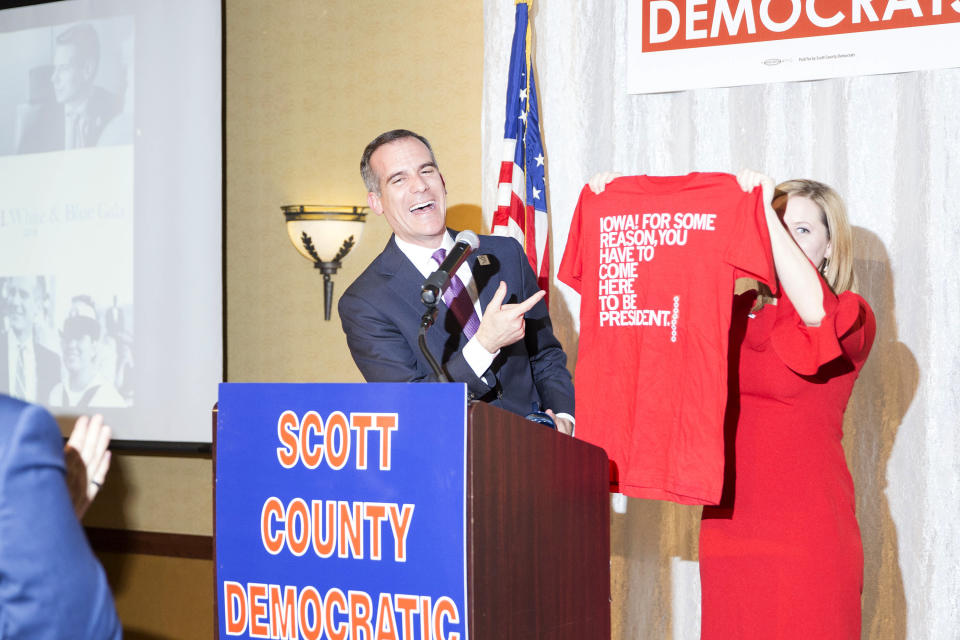 Garcetti receives a shirt from the Iowa clothing company Raygun that reads, “<span class="s1">Iowa! for Some Reason, You Have to Come Here to Be President</span>” during the Scott County Democrats Red, White and Blue Gala in Davenport, Iowa, on April 14. (Photo: KC McGinnis for Yahoo News)