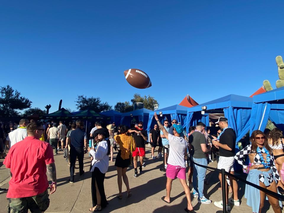 An inflatable football is tossed in the air at Gronk Beach.