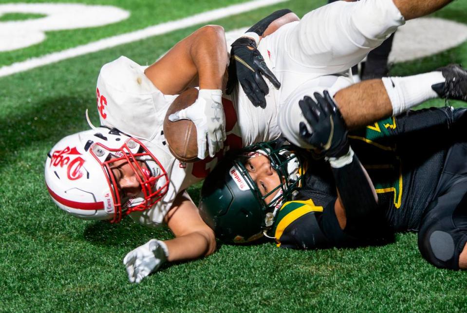 Isaac Vizcarra, 33, of Ceres High gets taken down by Chris Munoz, 14, of Davis High during a WAC game against Davis High on Friday Oct. 27, 2023.