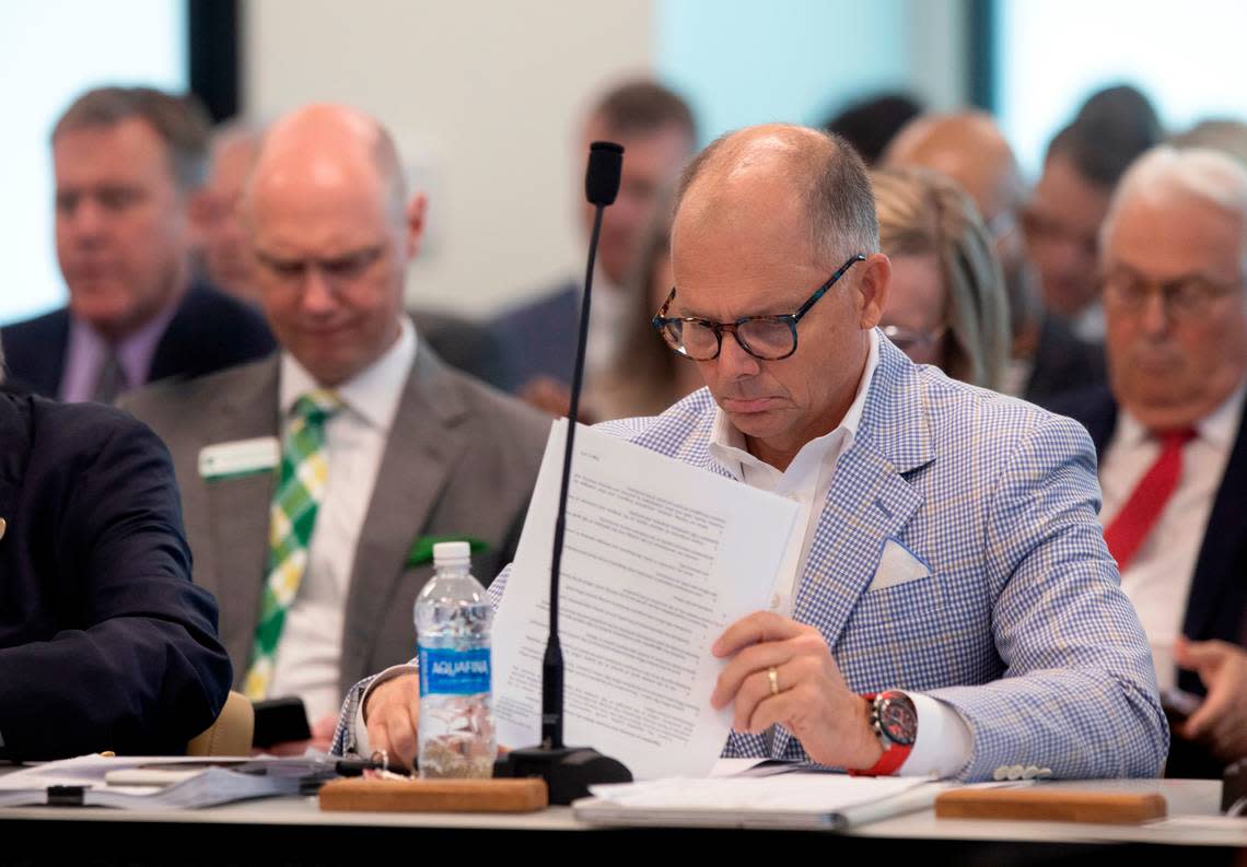 Woody White looks through documents during a meeting of the UNC System Board of Governors university governance committee on Wednesday, Sept. 11, 2024, in Raleigh, N.C.