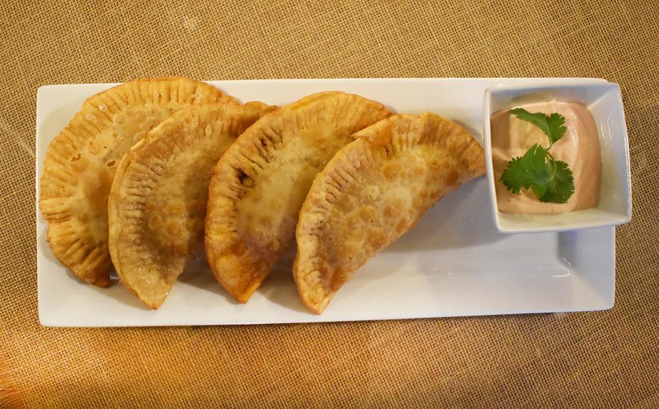 Puerto and Ecua Restaurant in Fall River serves beef empanadas with the house dip.