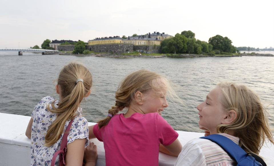 In this June 26, 2013 photo, young girls observe the Suomenlinna Fortress from the ferry that runs between Market Square and the Fortress in Helsinki, Finland. The Suomenlinna Fortress is a star-shaped bastion built in the 1700s. (AP Photo/Lehtikuva, Martti Kainulainen) FINLAND OUT