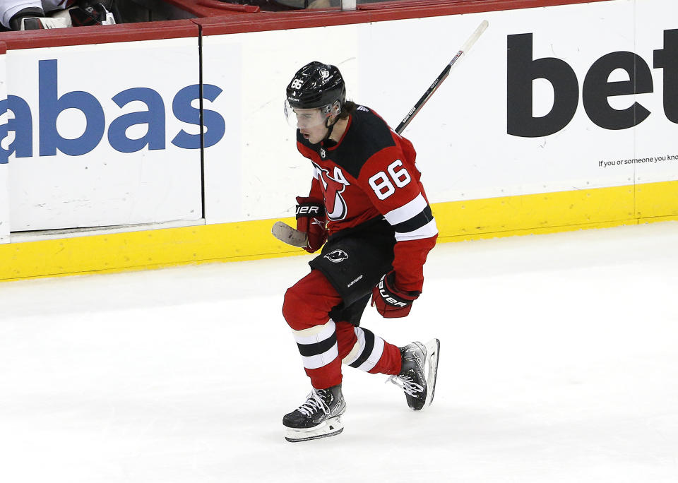 New Jersey Devils center Jack Hughes (86) reacts after scoring a goal against the Carolina Hurricanes during the third period of an NHL hockey game, Saturday, Jan. 22, 2022, in Newark, N.J. (AP Photo/Noah K. Murray)