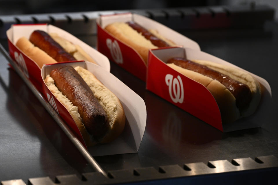 Hot dogs at Nationals Park before an exhibition baseball game between the Washington Nationals and the Washington Nationals Futures, Tuesday, March 26, 2024, in Washington. Most parks and arenas have a handful of areas that offer salads, gluten free or vegan offerings if fans are willing to hunt a little. But the vast majority of people attending baseball games aren't necessarily looking to eat healthy. (AP Photo/Nick Wass