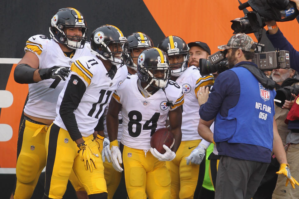 Antonio Brown celebrates with teammates for the cameras at an early season game. (Photo by John Grieshop/Getty Images)