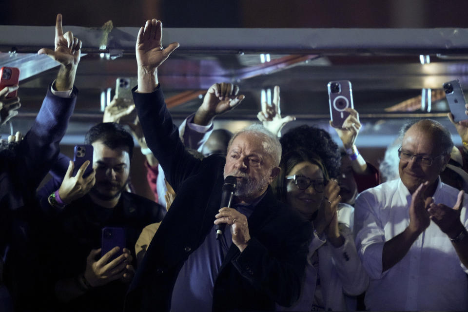 Former Brazilian President Luiz Inacio Lula da Silva, center, who is running for president again, speaks to supporters after general election polls closed in Sao Paulo, Brazil, Sunday, Oct. 2, 2022.(AP Photo/Andre Penner)