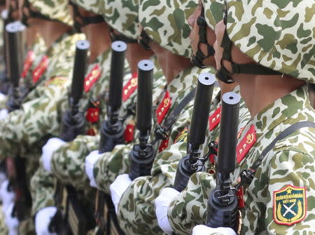Soldiers hold U.S.-designed, Israeli-made M4 rifles while marching during a celebration to mark Reunification Day in Ho Chi Minh city April 30, 2015. Photo taken April 30, 2015. REUTERS/Kham -