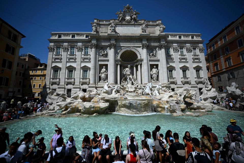 Tourists refresh themselves at the Trevi Fountain during a heat wave in Rome on Aug. 21 2023.