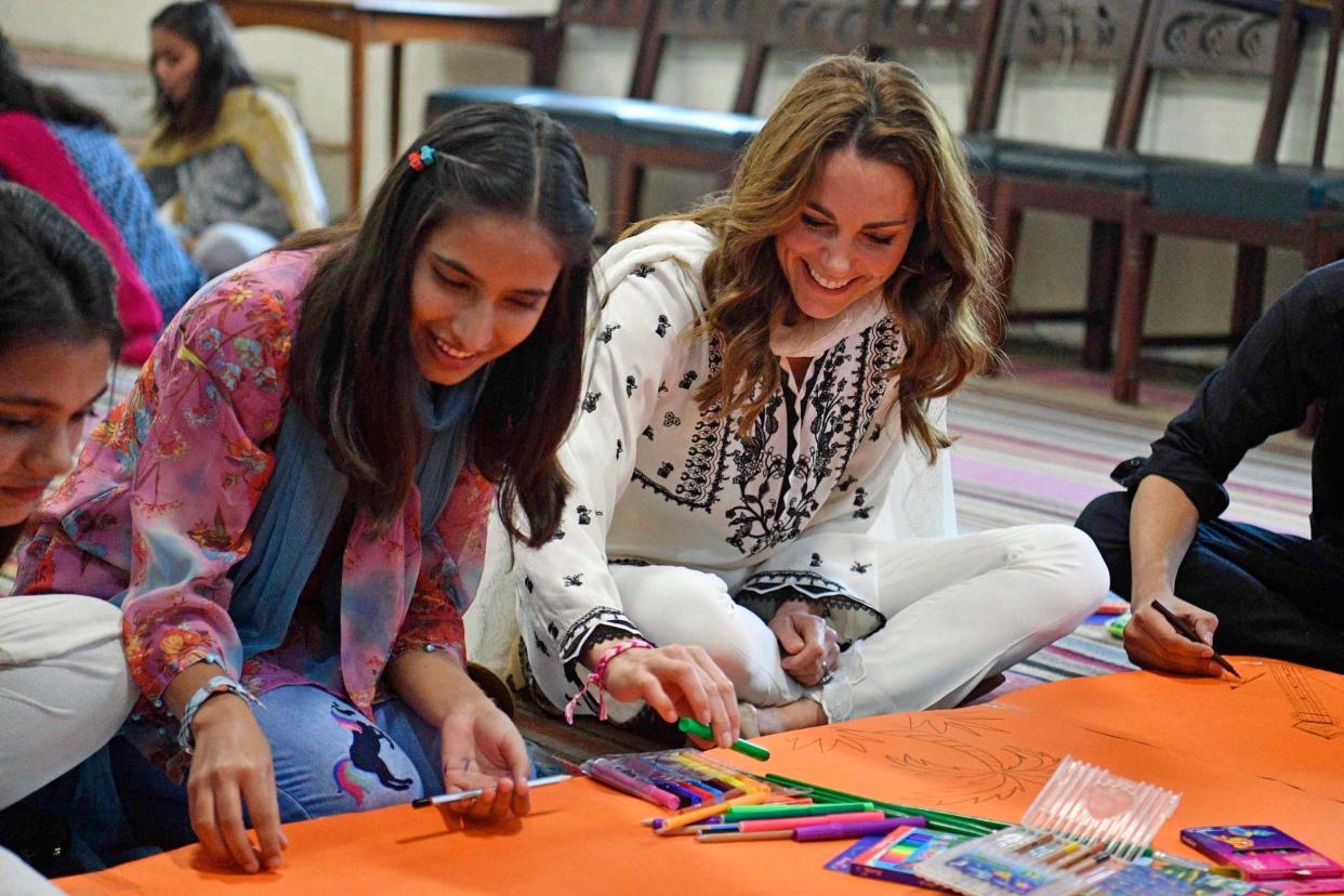 The Duchess of Cambridge joins in a drawing session during a visit to the SOS Village: PA