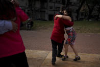 FILE - In this June 6, 2021 file photo, a couple dances tango at a park amid the COVID-19 pandemic lockdown in Buenos Aires, Argentina. Nostalgia for dance makes many tango dancers, or tangueros, defy restrictions with clandestine milongas in closed places or public spaces. (AP Photo/Natacha Pisarenko, File)