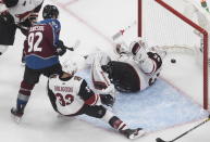 Arizona Coyotes goalie Darcy Kuemper (35) is scored as Colorado Avalanche's Gabriel Landeskog (92) and Coyotes' Alex Goligoski (33) battle in front during the third period of a first-round NHL Stanley Cup playoff hockey game in Edmonton, Ontario, on Wednesday, Aug. 12, 2020. (Jason Franson/The Canadian Press via AP)