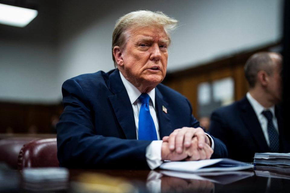 Former US president Donald Trump sits at the defence table at his criminal trial on charges of falsifying business records in New York (Reuters)