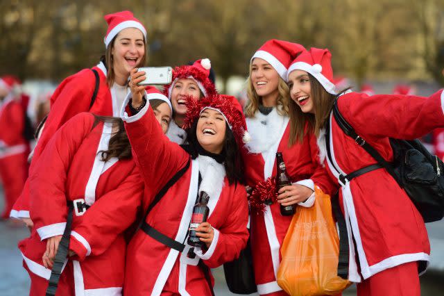 Participants gather at Kings Cross in London, prior to taking part in Santacon London 2017. (David Mirzeoff/PA)