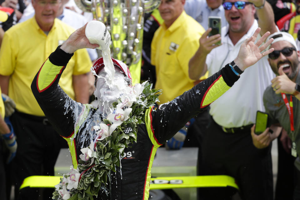 Simon Pagenaud, of France, celebrates by pouring milk on himself after winning the Indianapolis 500 IndyCar auto race at Indianapolis Motor Speedway, Sunday, May 26, 2019, in Indianapolis. (AP Photo/Michael Conroy)