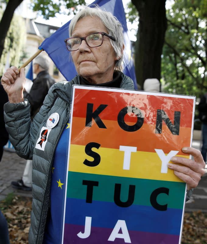 Protester holds a banner reading 'Constitution' during demonstration in Warsaw