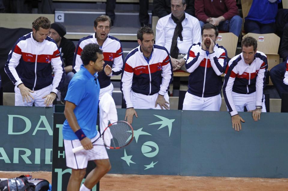 France's Jo-Wilfried Tsonga, foreground, gets encouragements from teammates, during his single match against Australia's Lleyton Hewitt, in the first round of the Davis Cup between France and Australia, in La Roche sur Yon, western France, Friday Jan. 31, 2014. France leads 2-0 at the end of the first day.(AP Photo/Remy de la Mauviniere)