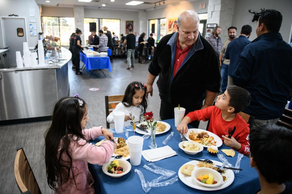 Robert Barefoot talks with Najeebullah Habibi during a meet up of recent Afghan refugees, veterans and others at Afghan Kabob on Sunday, Nov. 14, 2021.