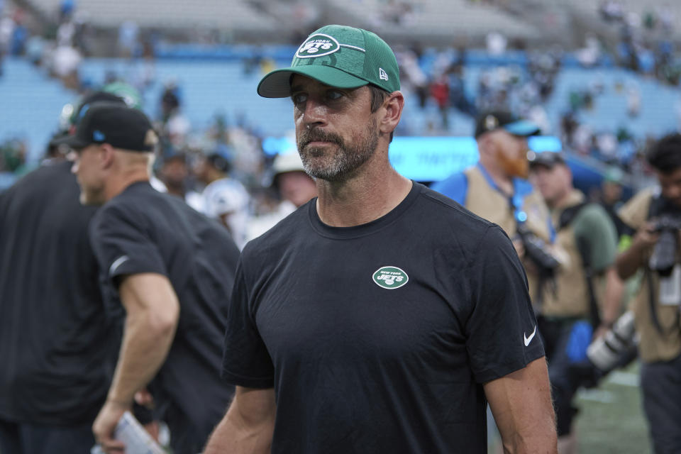 New York Jets quarterback Aaron Rodgers walks off the field following an NFL preseason football game against the Carolina Panthers, Saturday, Aug. 12, 2023, in Charlotte, N.C. (AP Photo/Brian Westerholt)