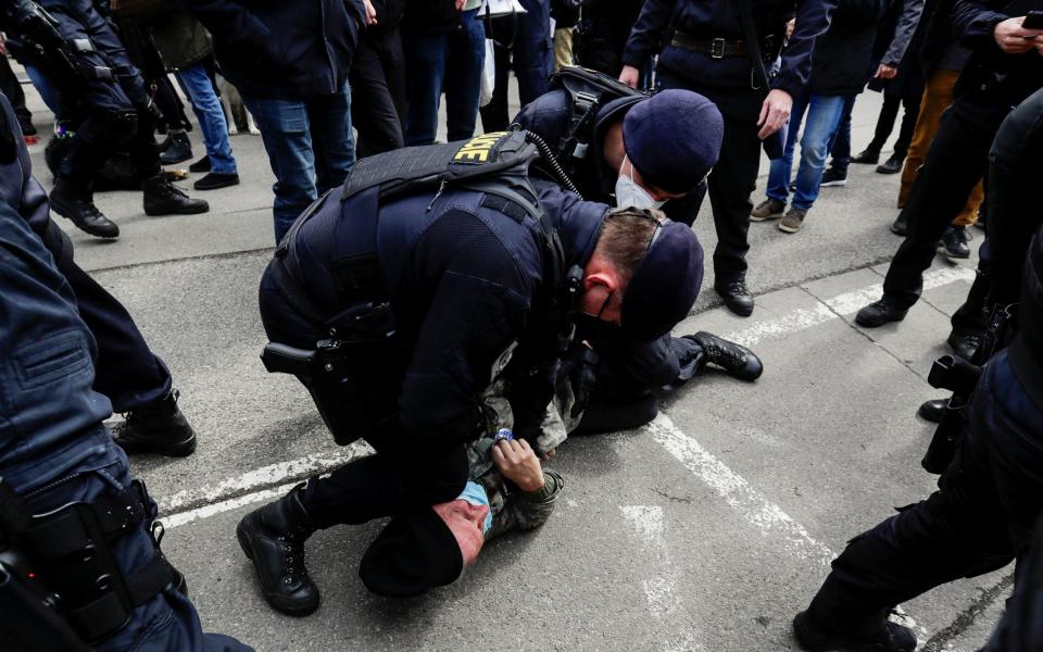 Police officers detain a counter-protester during a protest over Russian intelligence services alleged involvement in an ammunition depot explosion  - Reuters/Reuters