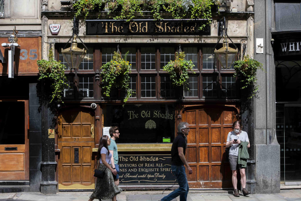 Members of the public passing by a closed pub due to the coronavirus pandemic. Pubs are among the hospitality list allowed to reopen from July 4th.