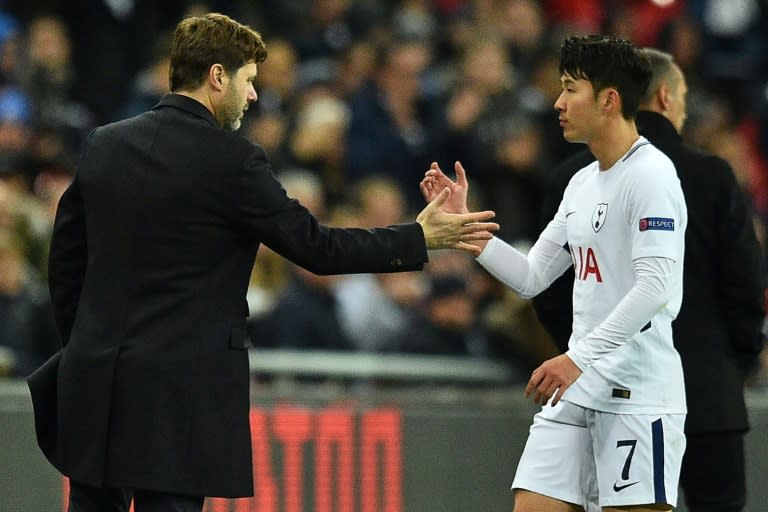 Tottenham Hotspur's head coach Mauricio Pochettino (L) shakes hands with Tottenham Hotspur's striker Son Heung-Min