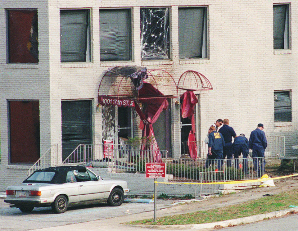 FILE - Law enforcement agents from the FBI and the Bureau of Alcohol, Tobacco and Firearms search the ground outside the New Woman All Women Health Care clinic in Birmingham, Ala., on Jan. 29, 1998. A bomb exploded outside the clinic early Thursday, killing an off-duty Birmingham police officer and a clinic nurse. Harassment and violence have become common outside abortion clinics over the decades since the landmark 1973 ruling legalizing abortion. Now providers and some in law enforcement worry what will come next. (AP Photo/Caroline Baird)