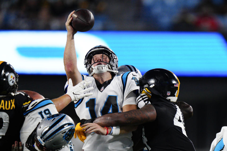 Carolina Panthers quarterback Sam Darnold tries to pass under pressure form Pittsburgh Steelers linebacker Robert Spillane during the first half of a preseason NFL football game Friday, Aug. 27, 2021, in Charlotte, N.C. (AP Photo/Jacob Kupferman)