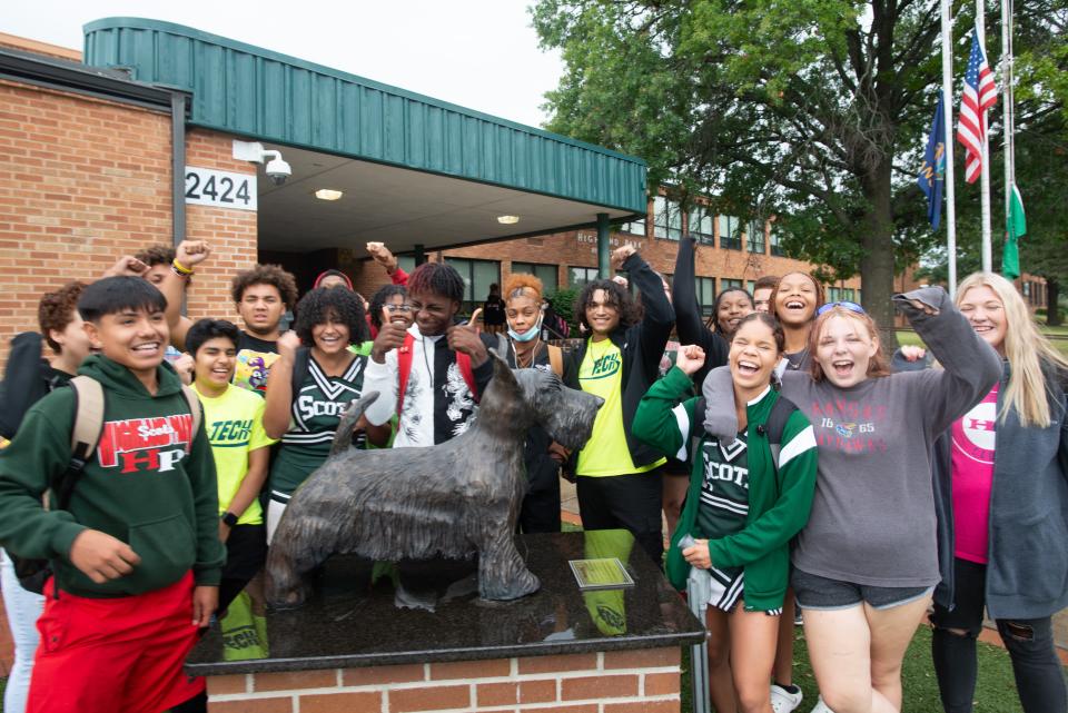 A group of Highland Park students yell out as they stand around a statue of their school's mascot, a Scottie dog, over their lunch period Friday.