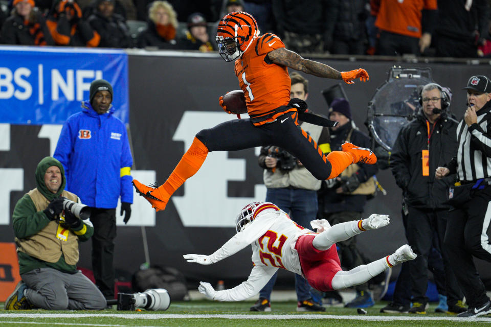 Cincinnati Bengals wide receiver Ja'Marr Chase (1) leaps over Kansas City Chiefs safety Juan Thornhill (22) in the first half of an NFL football game in Cincinnati, Sunday, Dec. 4, 2022. (AP Photo/Jeff Dean)