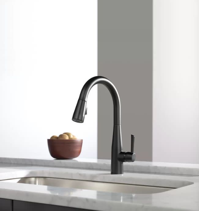 Did black really ever go out of style? We think not. But according to Pinterest, the color is back as searches for black home decor, like black kitchen sinks, has been trending +252%. Get this <a href="https://www.wayfair.com/home-improvement/pdp/delta-essa-pull-down-touchless-single-handle-kitchen-faucet-with-magnatite-docking-and-diamond-seal-technology-dlt7337.html?piid=15361221" target="_blank">matte black Delta faucet that's now 40% off</a> on Wayfair.