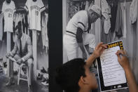 Camilo Otero, 9, tries to answer questions about the life of late Major League Baseball player Roberto Clemente, as kids from the Marlins Nike RBI youth sports program visit a traveling exhibit titled "3000," in a nod to Clemente's 3000 career hits, at Miami Marlins' loanDepot Park in Miami, Wednesday, Jan. 31, 2024. The tribute to the Pittsburgh Pirates outfielder will be on display at the park during baseball's Caribbean Series, which runs from Feb. 1 through Feb. 9. (AP Photo/Rebecca Blackwell)