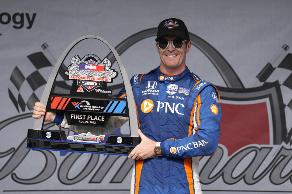 Scott Dixon holds the first place trophy following an IndyCar auto race at World Wide Technology Raceway, Sunday, Aug. 27, 2023, in Madison, Ill. (AP Photo/Jeff Roberson)