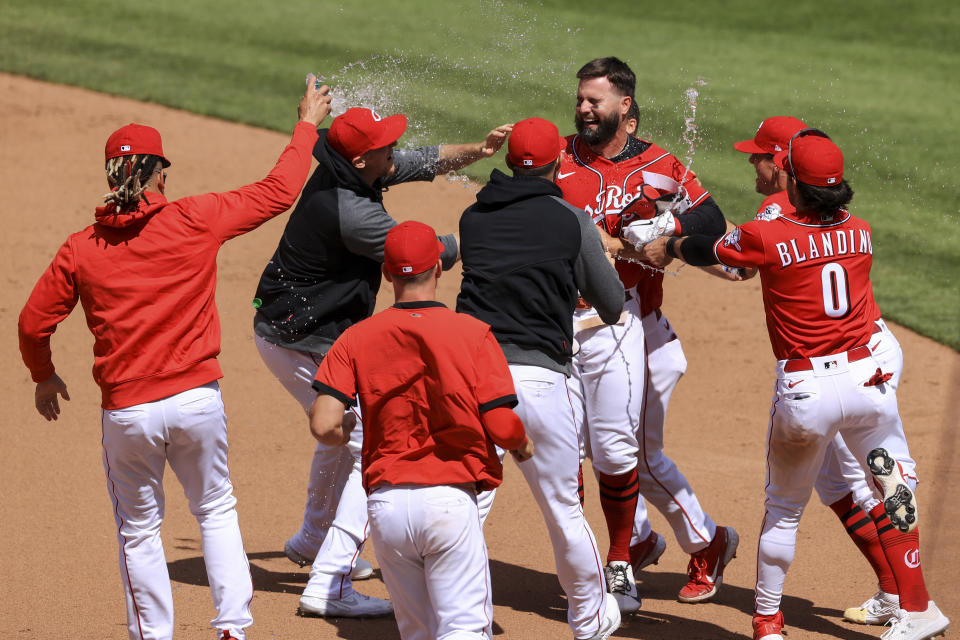 Cincinnati Reds' Jesse Winker, back right, celebrates with teammates after hitting an RBI walk-off single during the tenth inning of a baseball game against the Chicago White Sox in Cincinnati, Wednesday, May 5, 2021. The Reds won 1-0. (AP Photo/Aaron Doster)