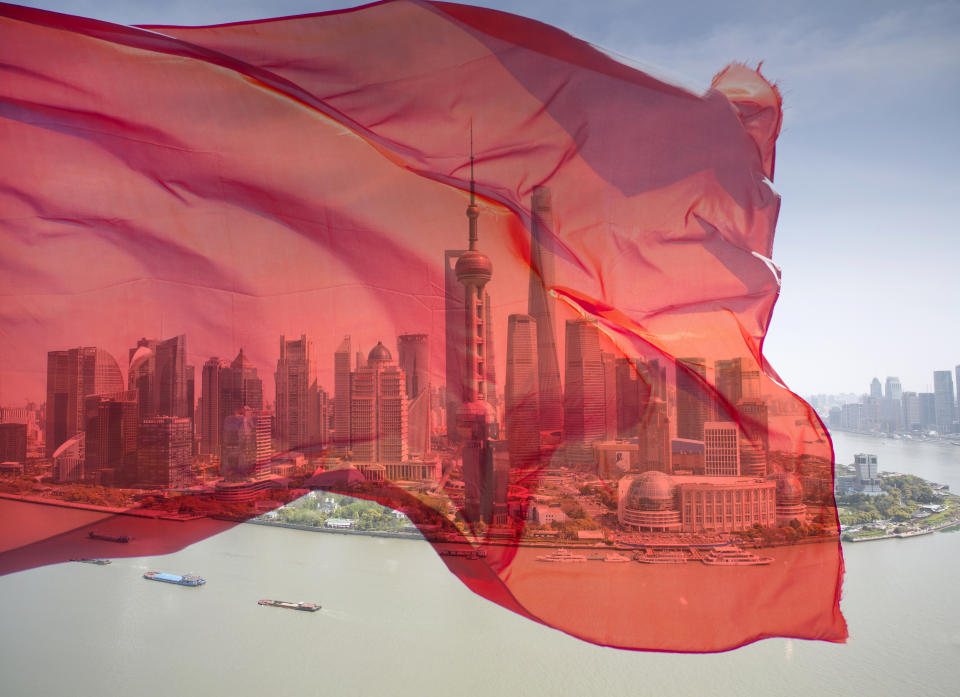 Pudong business district with Chinese flag.