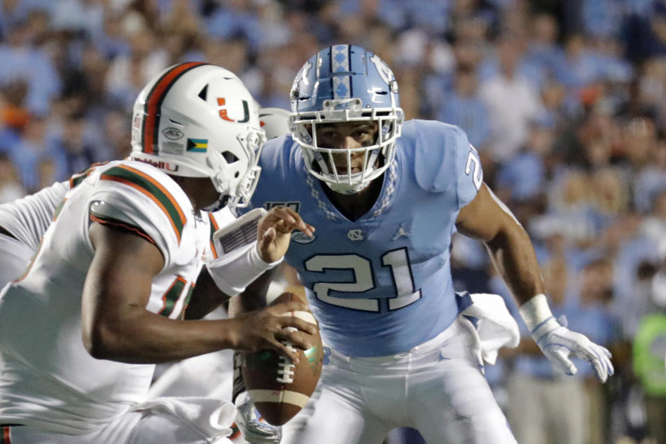 FILE - In this Sept. 7, 2019, file photo, Miami quarterback Jarren Williams (15) is pressured by North Carolina's Chazz Surratt (21) during the first half of an NCAA college football game in Chapel Hill, N.C. Chazz Surratt was selected to The Associated Press All-Atlantic Coast Conference football team, Tuesday, Dec. 10, 2019. (AP Photo/Chris Seward, File)